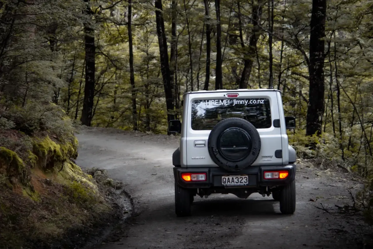 Suzuki Jimny in scenic South Island setting. – Jimny Rentals.